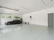 Spacious garage with high ceilings and polished concrete floor at 10230 Park Ridge Gotha Rd, Windermere, FL 34786