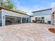 Modern two-car garage with glass paneled doors and paver driveway at 10230 Park Ridge Gotha Rd, Windermere, FL 34786