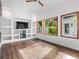 Bright Gathering room featuring built-in shelving and hardwood floors at 10230 Park Ridge Gotha Rd, Windermere, FL 34786
