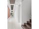 Bright hallway with dark hardwood stairs and white walls at 10230 Park Ridge Gotha Rd, Windermere, FL 34786