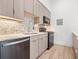 Modern kitchen with wood cabinets and hexagon tile backsplash at 10230 Park Ridge Gotha Rd, Windermere, FL 34786