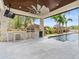 Outdoor kitchen with stainless steel appliances and a pool view at 10230 Park Ridge Gotha Rd, Windermere, FL 34786