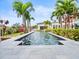 Long, rectangular pool surrounded by lush landscaping at 10230 Park Ridge Gotha Rd, Windermere, FL 34786