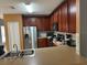 Kitchen with stainless steel appliances and wooden cabinetry at 1403 Kissimmee Ct, Kissimmee, FL 34759