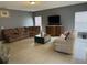 Spacious living room with tile floors and ample seating at 1403 Kissimmee Ct, Kissimmee, FL 34759