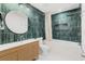Modern bathroom with green tile, freestanding tub, and vanity at 2330 Westminster Ct, Winter Park, FL 32789