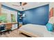 Cozy bedroom with a blue accent wall and a built-in workspace at 2330 Westminster Ct, Winter Park, FL 32789