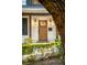 Wood front door accented with lanterns and a brick walkway at 2330 Westminster Ct, Winter Park, FL 32789