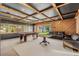 Game room features a pool table, seating area, and wood-paneled walls at 2330 Westminster Ct, Winter Park, FL 32789