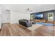 Gathering room with sectional sofa, large TV, and wood feature wall at 2330 Westminster Ct, Winter Park, FL 32789