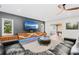 Gathering room features a sectional sofa, large TV, and hardwood floors at 2330 Westminster Ct, Winter Park, FL 32789