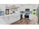 Modern kitchen with white cabinets, blue tile backsplash, and stainless steel appliances at 2330 Westminster Ct, Winter Park, FL 32789