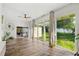 Sunroom features hardwood floors and large windows overlooking the backyard at 2330 Westminster Ct, Winter Park, FL 32789
