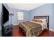 Spacious bedroom with wood floors and a large bed at 3279 Fairfield Dr, Kissimmee, FL 34743