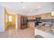 Modern kitchen with light wood cabinets, granite countertops, and stainless steel appliances at 3279 Fairfield Dr, Kissimmee, FL 34743
