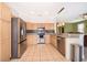 Modern kitchen with light wood cabinets, granite countertops, and stainless steel appliances at 3279 Fairfield Dr, Kissimmee, FL 34743
