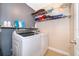 Laundry room with washer, dryer, and shelving at 3279 Fairfield Dr, Kissimmee, FL 34743