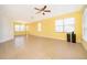 Bright living room with yellow walls, tile floors, and lots of natural light at 3279 Fairfield Dr, Kissimmee, FL 34743
