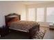 Bright bedroom with wood flooring, large windows, and a comfortable bed at 428 Palastro Ave, Auburndale, FL 33823