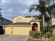 Two-story house with a two-car garage and manicured landscaping at 433 Eastbridge Dr, Oviedo, FL 32765