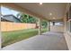 Covered patio overlooking a fenced backyard at 510 Palm Ave, Eustis, FL 32726
