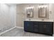 Elegant bathroom with double vanity, marble shower, and modern fixtures at 510 Palm Ave, Eustis, FL 32726