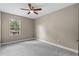 Well-lit bedroom featuring a ceiling fan and large window at 510 Palm Ave, Eustis, FL 32726