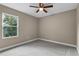 Well-lit bedroom with carpet flooring and a window at 510 Palm Ave, Eustis, FL 32726