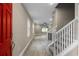 Bright entryway with red door, tile flooring, and staircase leading upstairs at 510 Palm Ave, Eustis, FL 32726