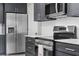 Modern kitchen with stainless steel appliances and dark cabinets at 510 Palm Ave, Eustis, FL 32726