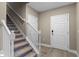 Modern staircase with white railings leading to the upper level at 510 Palm Ave, Eustis, FL 32726