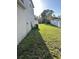 Grass backyard with a white fence and AC unit at 1005 Chase Dr, Winter Garden, FL 34787