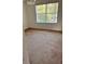 Bright bedroom featuring carpeted floors and a large window at 1005 Chase Dr, Winter Garden, FL 34787