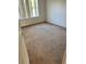 Simple carpeted bedroom with a window and neutral-colored walls at 1005 Chase Dr, Winter Garden, FL 34787