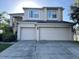 Two-story house with a two-car garage and a well-maintained lawn at 1005 Chase Dr, Winter Garden, FL 34787