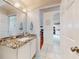 Guest bathroom with granite vanity and view to kitchen at 110 Coleman St, Edgewater, FL 32141