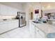 Bright kitchen with white cabinets, granite countertops, and stainless steel appliances at 110 Coleman St, Edgewater, FL 32141