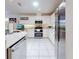 Bright kitchen featuring white cabinets, granite counters, and breakfast bar at 110 Coleman St, Edgewater, FL 32141