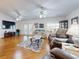 Bright living room with hardwood floors, comfortable seating, and ceiling fan at 110 Coleman St, Edgewater, FL 32141