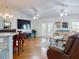 Open living room with hardwood floors, large TV, and access to patio at 110 Coleman St, Edgewater, FL 32141