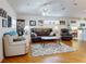 Comfortable living room with hardwood floors, leather furniture, and ceiling fan at 110 Coleman St, Edgewater, FL 32141