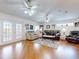 Spacious living room with hardwood floors, ceiling fan and access to patio at 110 Coleman St, Edgewater, FL 32141