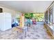 Large screened porch with furniture and game at 110 Coleman St, Edgewater, FL 32141