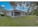 House exterior with screened patio and grassy yard at 1175 Chessington Cir, Lake Mary, FL 32746