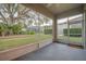 Relaxing screened porch overlooking backyard and trees at 1175 Chessington Cir, Lake Mary, FL 32746
