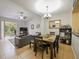 Open concept dining area with seating for four and access to the living room at 1542 Travertine Ter, Sanford, FL 32771
