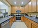 Modern kitchen featuring stainless steel appliances and granite countertops at 1542 Travertine Ter, Sanford, FL 32771