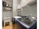 Laundry room with washer, dryer, shelving, and utility sink at 1542 Travertine Ter, Sanford, FL 32771