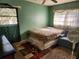 Serene bedroom with a double bed, armchair, and window with curtains at 1701 N Hastings St, Orlando, FL 32808