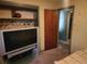 Cozy bedroom with a double bed, dresser, and large TV at 1701 N Hastings St, Orlando, FL 32808